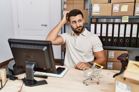 latino business owner thinking scratching head